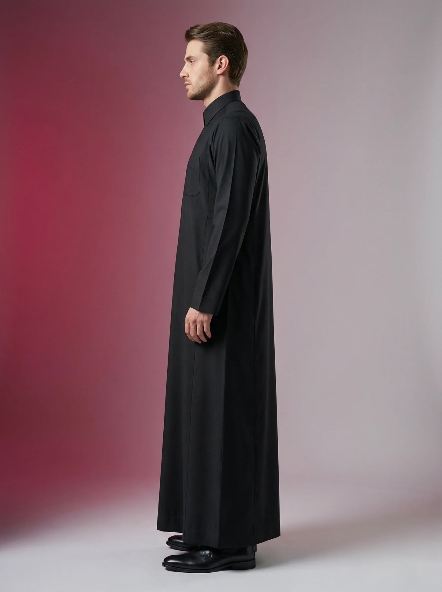 Carbon Black Executive Thobe side profile showcasing modern tailoring, premium breathable fabric, concealed placket, and executive Saudi-inspired styling. Luxury men's thobe, premium Saudi jubba, Islamic menswear, ثوب كربوني أسود أنيق, ثوب رجالي فاخر, ثوب سعودي مودرن, جلابية رجالية راقية, دشداشة رجالية حديثة, modest fashion designed for professionals and elevated daily wear.