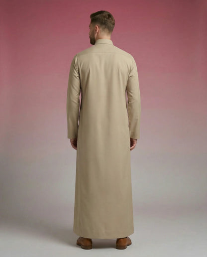 Desert Beige Classic Thobe Timeless Warm Elegance featuring premium tailoring, concealed front placket, refined shirt collar, and breathable luxury fabric. Luxury Saudi thobe, men's Islamic clothing, premium jubba, ثوب سعودي رجالي, ثوب بيج فاخر, ثوب رسمي للرجال, جلابية رجالية كلاسيكية, دشداشة رجالية حديثة, elegant modest fashion suitable for Jummah prayer, work environments, Eid celebrations, Ramadan gatherings, and everyday sophistication.