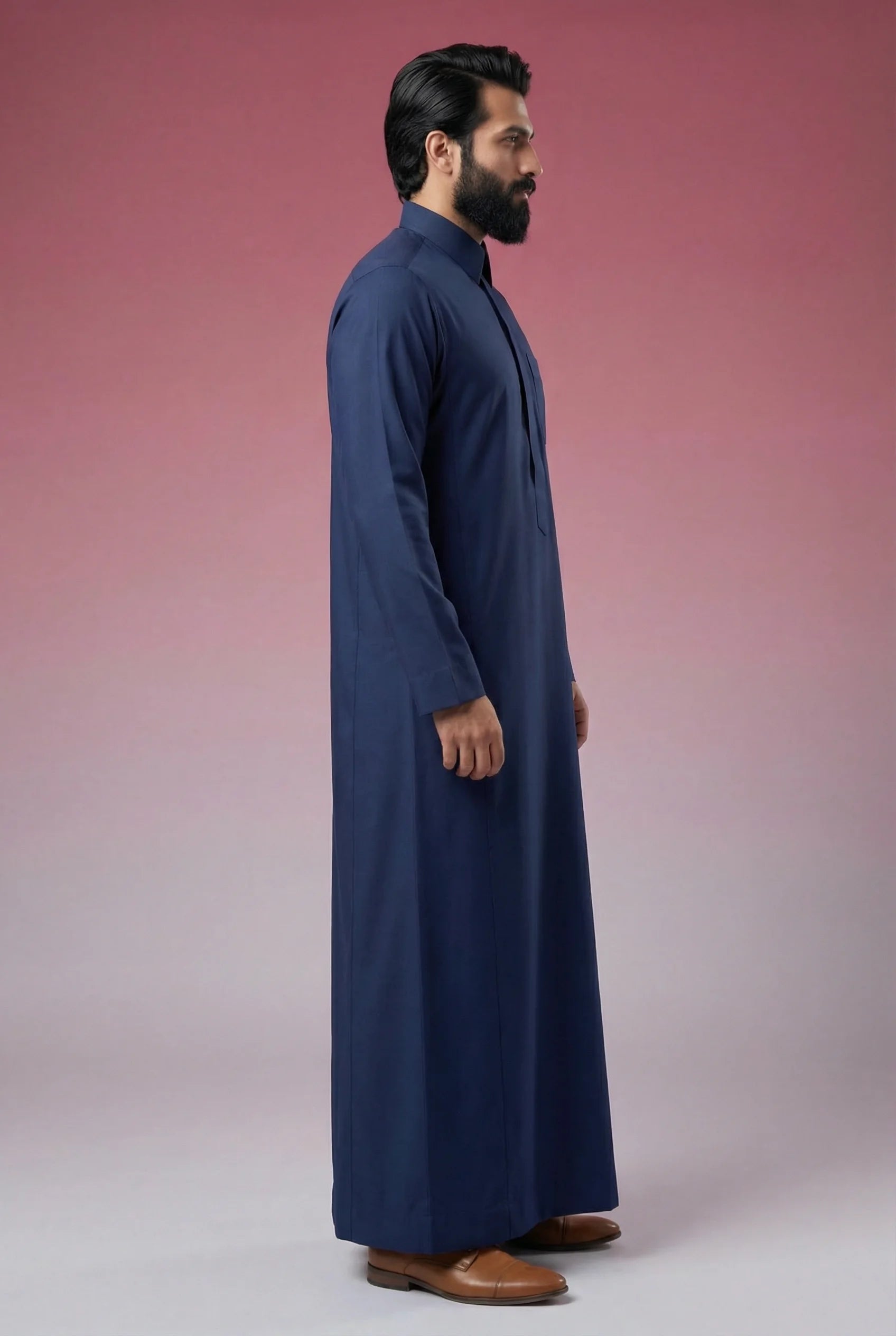 Side profile of Midnight Blue Classic Thobe displaying modern tailoring, streamlined silhouette, structured collar, and lightweight breathable fabric. Luxury men's thobe, Saudi jubba, Arabic clothing, ثوب سعودي أنيق, ثوب رجالي فاخر, ثوب أزرق كحلي, دشداشة رجالية رسمية, جلابية رجالية مودرن, premium Islamic menswear crafted for office wear, Ramadan gatherings, Eid celebrations, and sophisticated daily use.
