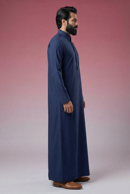 Side profile of Midnight Blue Classic Thobe displaying modern tailoring, streamlined silhouette, structured collar, and lightweight breathable fabric. Luxury men's thobe, Saudi jubba, Arabic clothing, ثوب سعودي أنيق, ثوب رجالي فاخر, ثوب أزرق كحلي, دشداشة رجالية رسمية, جلابية رجالية مودرن, premium Islamic menswear crafted for office wear, Ramadan gatherings, Eid celebrations, and sophisticated daily use.
