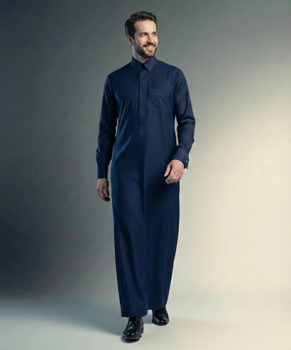 Walking view of Navy Blue Premium Formal Thobe featuring confident style, breathable comfort, executive tailoring, concealed placket, and timeless sophistication suitable for office wear, formal events, and distinguished occasions. إطلالة أثناء المشي لثوب أزرق كحلي فاخر تبرز الأناقة العصرية والراحة العالية والخياطة المتقنة للرجل الواثق والأنيق.