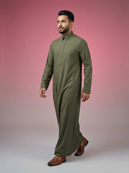 Olive Green Premium Thobe in walking side profile showcasing elegant movement, premium tailoring, breathable fabric, concealed placket, and timeless Saudi design. Luxury men's thobe, Saudi jubba, Arabic menswear, ثوب أخضر زيتوني فاخر, ثوب رجالي أنيق, ثوب رسمي رجالي, جلابية رجالية راقية, دشداشة رجالية مودرن, premium Islamic fashion suitable for business, prayer, Ramadan, Eid, and special occasions.