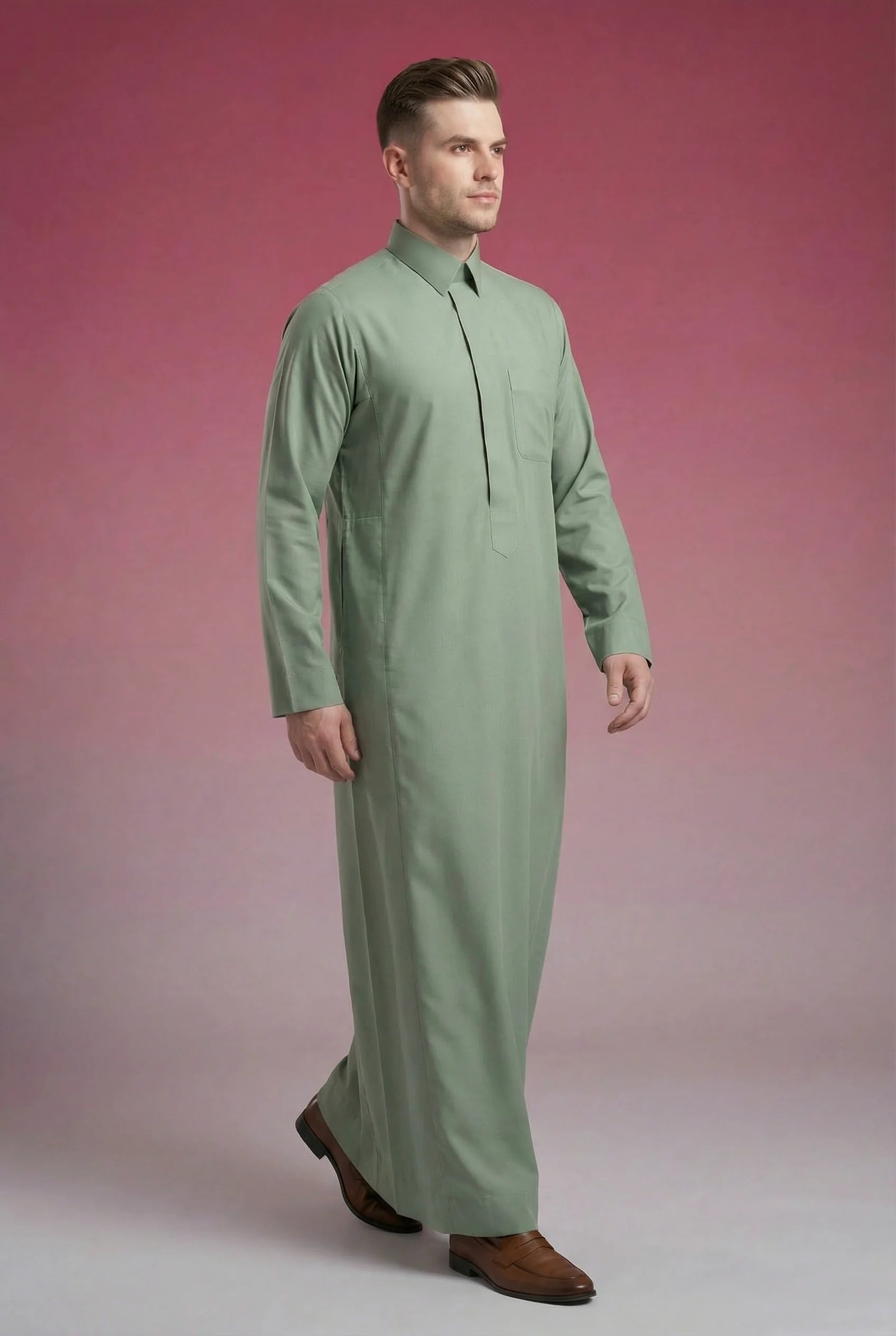Sage Green Classic Thobe in walking side profile showcasing elegant movement, breathable premium fabric, concealed placket, and refined Saudi design. Luxury men's thobe, Saudi jubba, Arabic menswear, ثوب أخضر سيج فاخر, ثوب رجالي أنيق, ثوب رسمي رجالي, جلابية رجالية راقية, دشداشة رجالية مودرن, premium Islamic fashion suitable for business, prayer, Ramadan, Eid, and special occasions.
