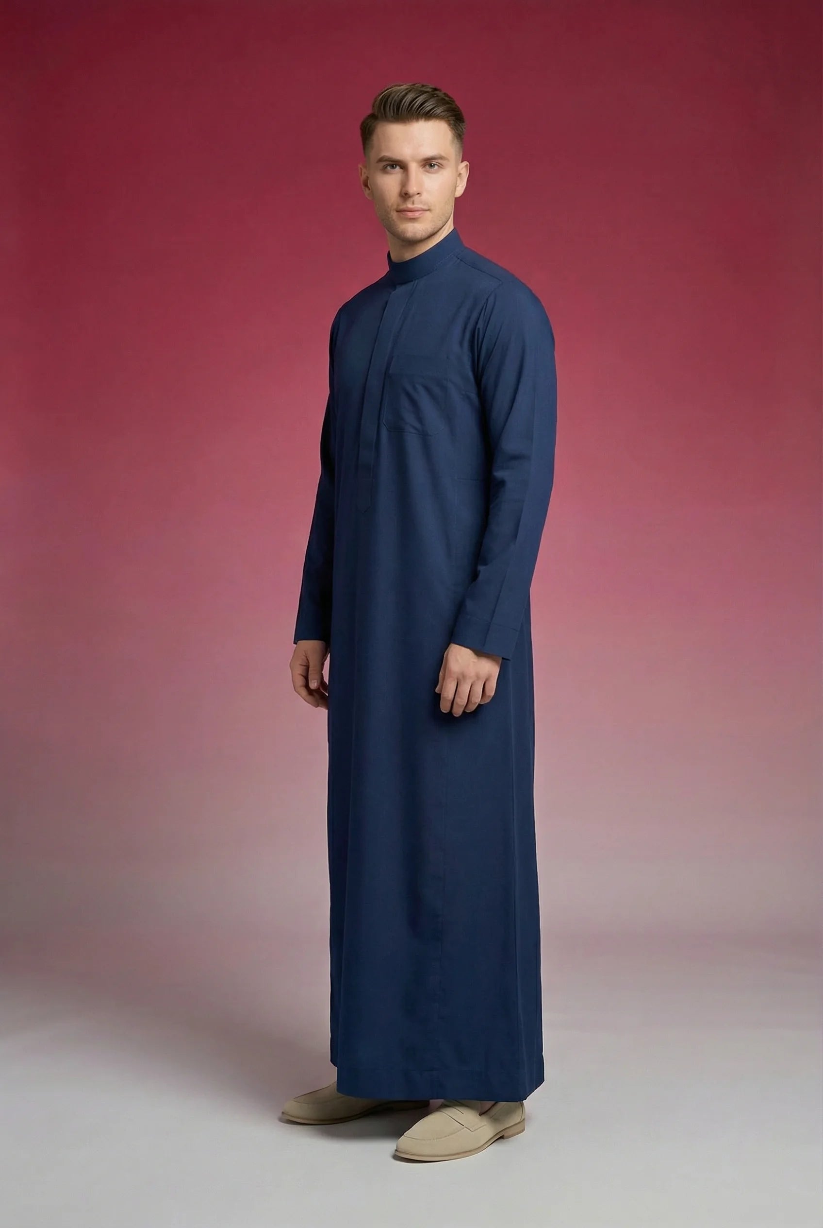 Side profile of Slate Blue Classic Thobe displaying streamlined tailoring, elegant band collar, premium fabric, and refined modern silhouette. Luxury men's thobe, Saudi jubba, Arabic menswear, ثوب سعودي أنيق, ثوب رجالي فاخر, ثوب أزرق أردوازي, ثوب كحلي رجالي, دشداشة رجالية رسمية, جلابية رجالية مودرن, premium Islamic clothing ideal for daily wear, office use, Ramadan, Eid, and formal occasions.