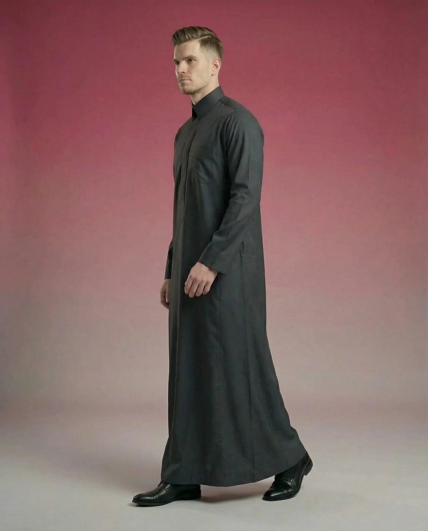 Smoke Black Classic Thobe in walking side profile showcasing elegant movement, breathable premium fabric, concealed placket, and refined Saudi design. Luxury men's thobe, Saudi jubba, Arabic menswear, ثوب فحمي فاخر, ثوب أسود أنيق, ثوب رجالي رسمي, جلابية رجالية راقية, دشداشة رجالية مودرن, premium Islamic fashion suitable for business, prayer, Ramadan, Eid, and special occasions.