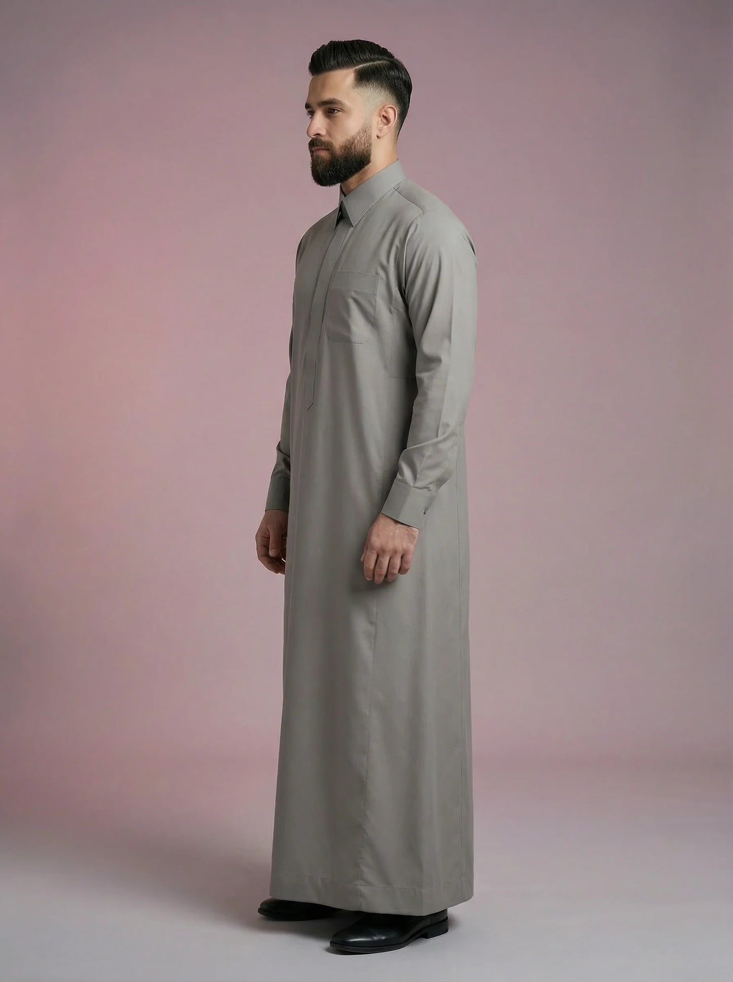 Side profile of Urban Stone Grey Saudi Thobe displaying elegant proportions, premium fabric flow, minimalist detailing, and structured turn-down collar. Contemporary Islamic menswear combining traditional modesty with modern refinement for work, worship, and social occasions.
