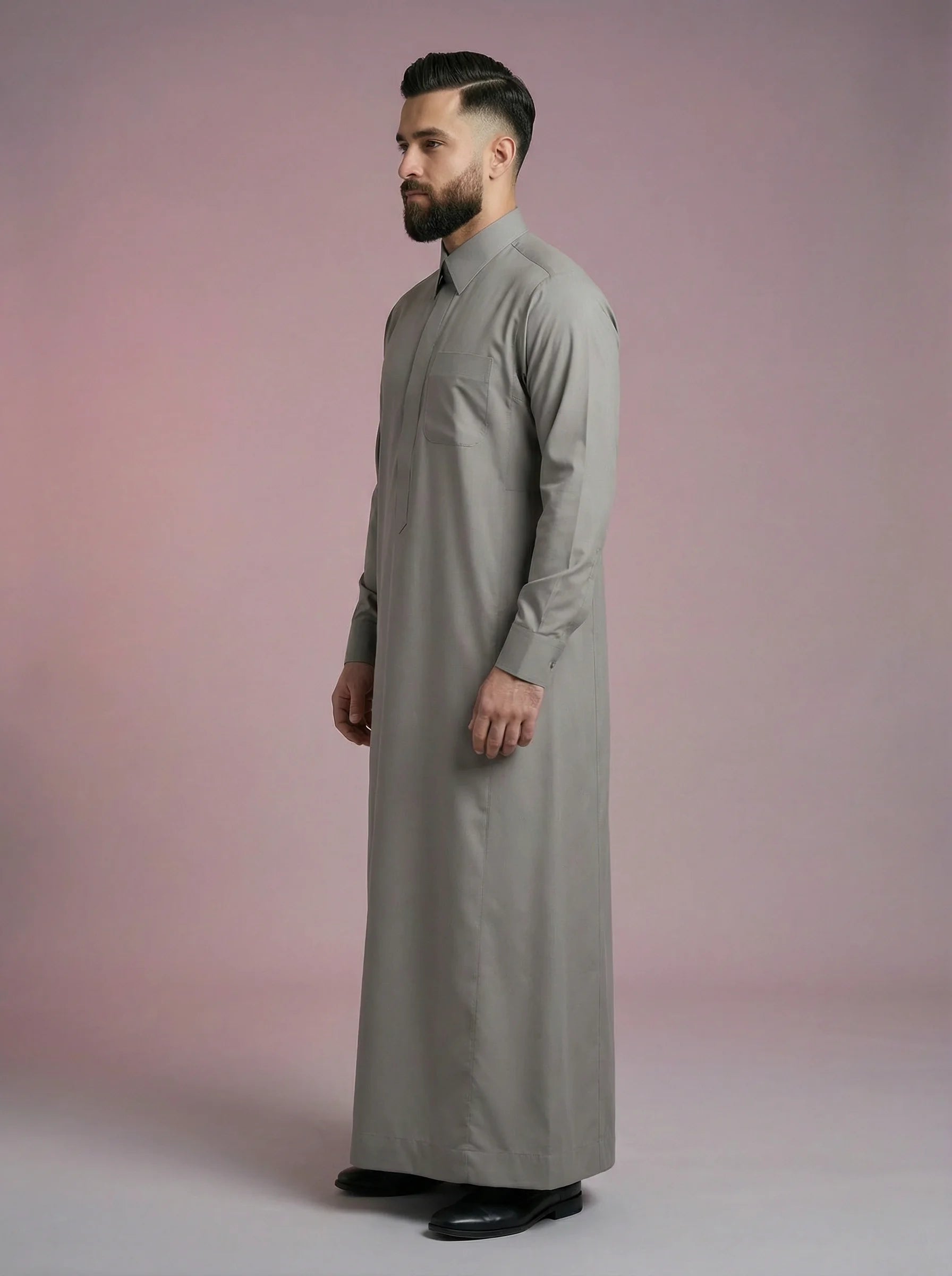 Side profile of Urban Stone Grey Saudi Thobe displaying elegant proportions, premium fabric flow, minimalist detailing, and structured turn-down collar. Contemporary Islamic menswear combining traditional modesty with modern refinement for work, worship, and social occasions.