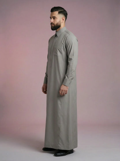 Side profile of Urban Stone Grey Saudi Thobe displaying elegant proportions, premium fabric flow, minimalist detailing, and structured turn-down collar. Contemporary Islamic menswear combining traditional modesty with modern refinement for work, worship, and social occasions.