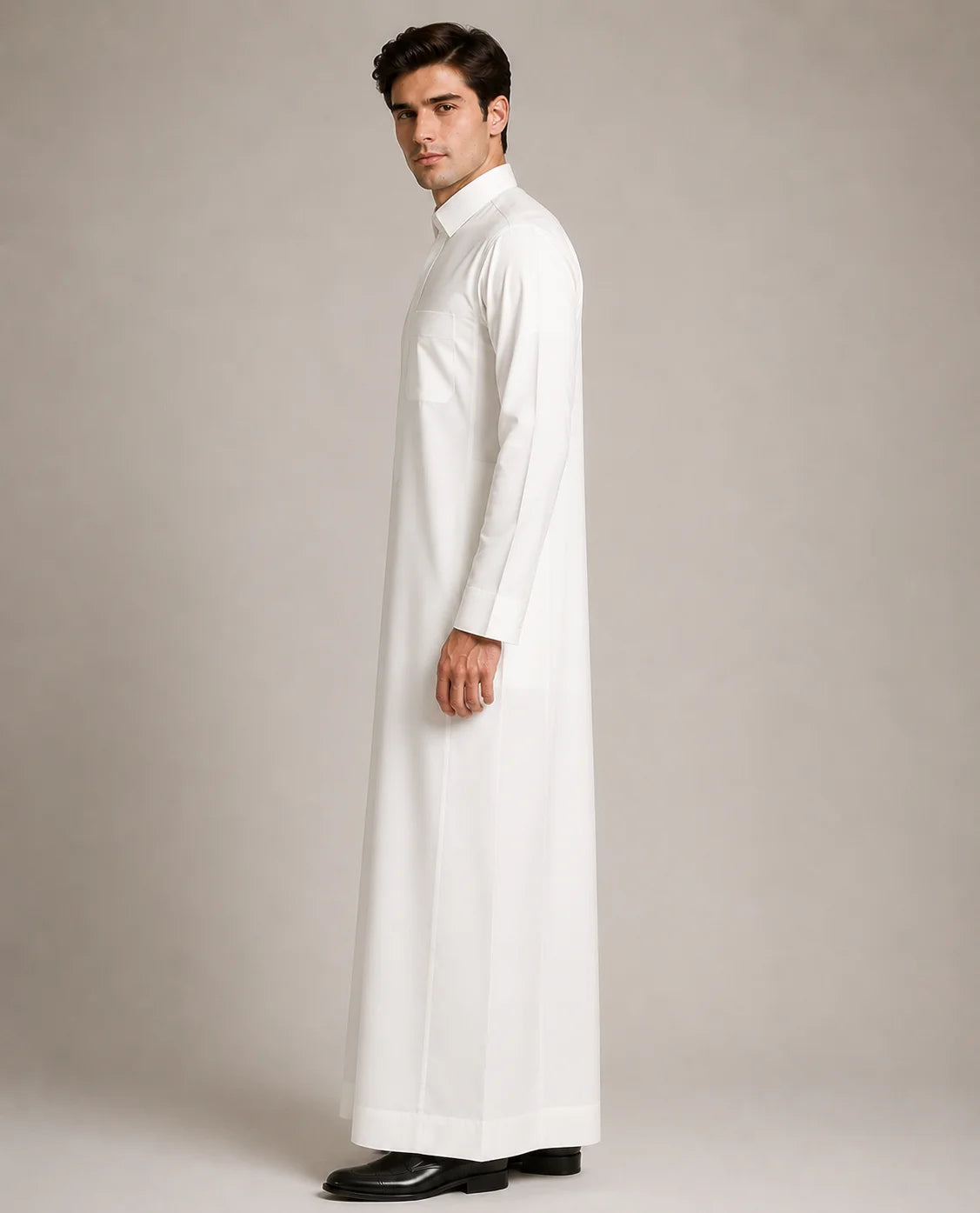 Side profile of Pearl White Classic men's thobe featuring streamlined fit, premium fabric and traditional Saudi Arabian styling