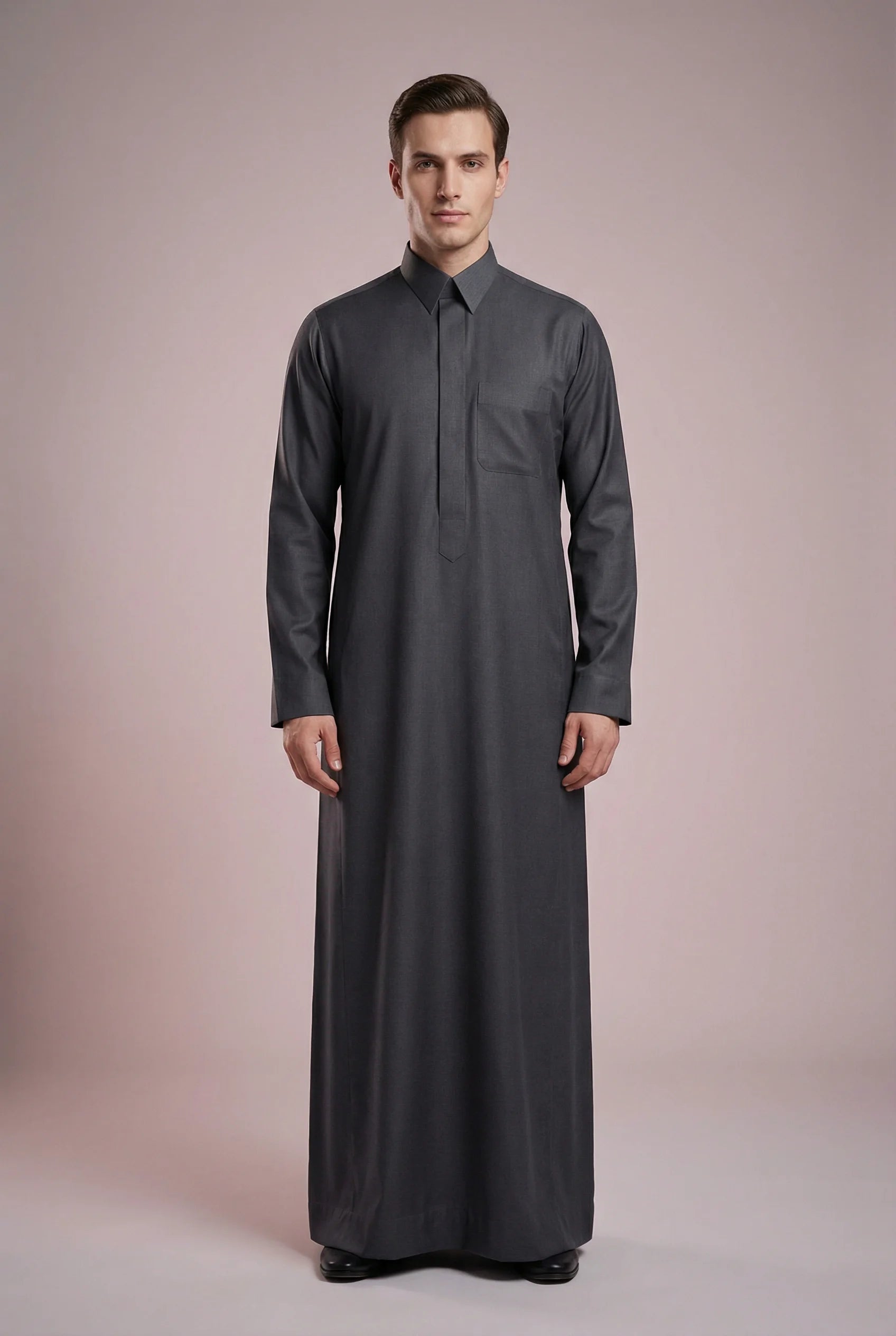 Front view of Charcoal Grey Signature Thobe featuring executive tailoring, hidden placket closure, structured collar, chest pocket detailing, and rich charcoal grey color. Premium Saudi thobe for men, luxury Islamic clothing, men's jubba, ثوب سعودي رجالي, ثوب رسمي فاخر, جلابية رجالية كلاسيكية, دشداشة رجالية حديثة, perfect for Eid, Jummah prayer, weddings, corporate gatherings, and upscale daily wear.