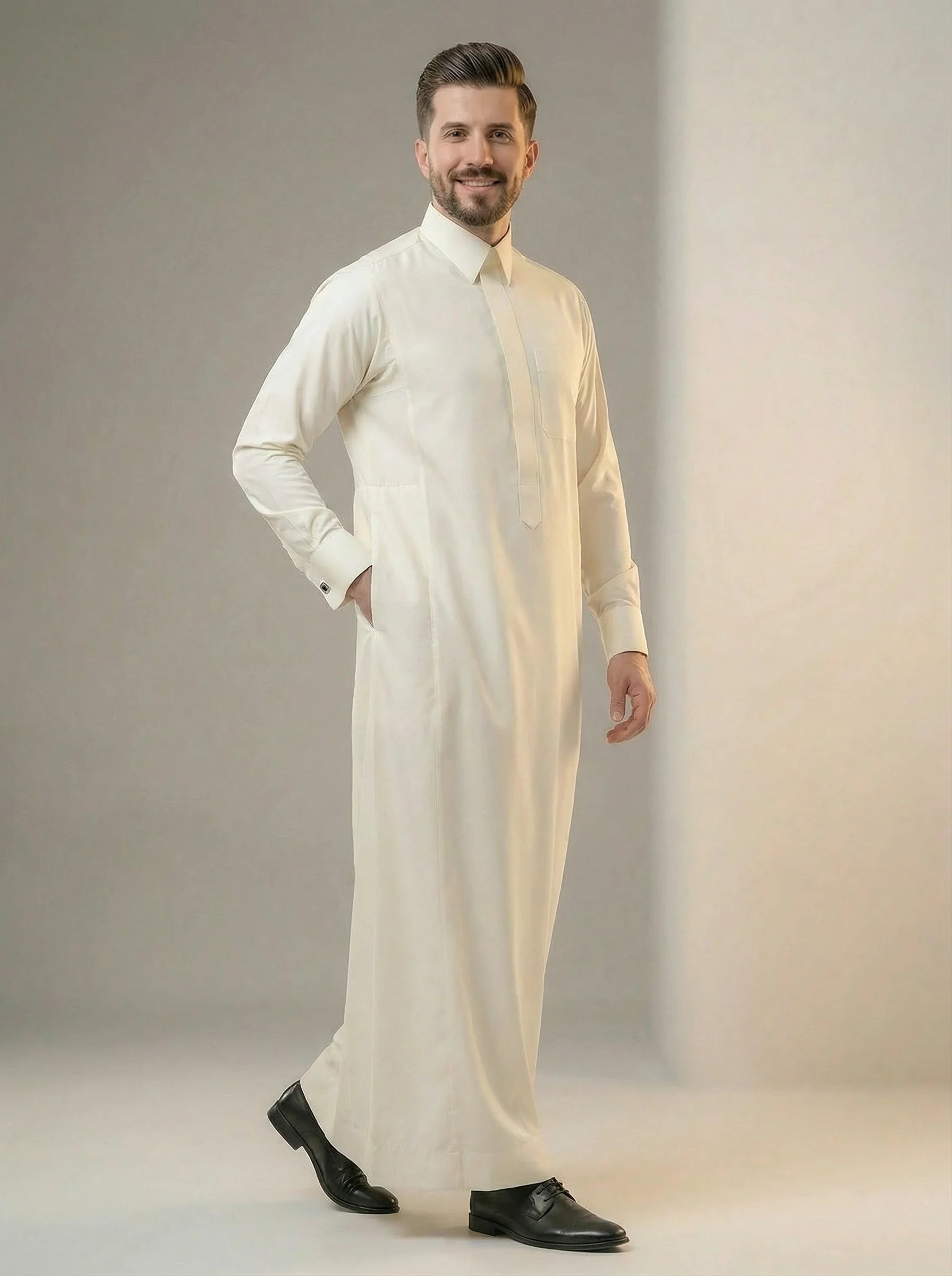 Front walking view of Cream White Premium Formal Thobe showcasing refined tailoring, premium cream-white fabric, concealed placket, structured collar, and sophisticated executive style. ثوب كريمي فاخر أثناء الحركة يبرز الانسيابية المثالية والتفصيل الراقي والحضور المميز للرجل الأنيق.