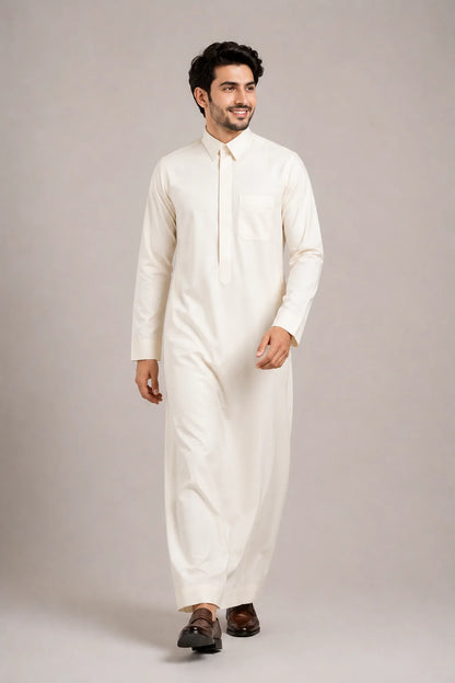 Man walking in Cream White Signature Saudi thobe showcasing premium craftsmanship, modern comfort and timeless everyday sophistication