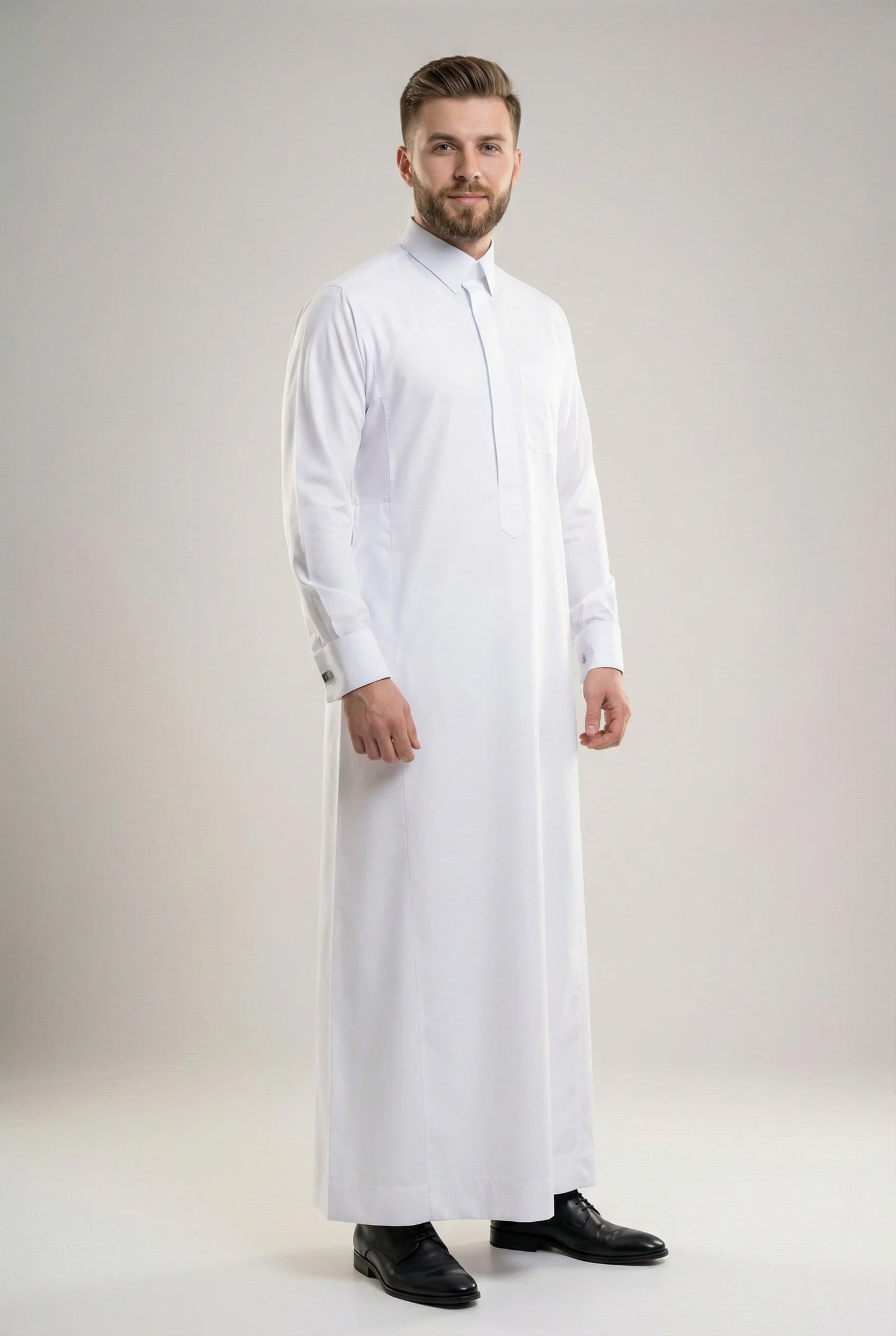 Front view of Imperial White Signature Thobe showcasing a refined executive fit, crisp white fabric, concealed placket, structured collar, premium craftsmanship, and sophisticated formal styling. ثوب أبيض فاخر بإطلالة أمامية يبرز الأناقة الراقية والتفصيل المتقن والحضور المميز للرجل العصري.