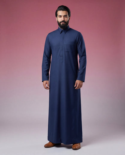 Front view of Midnight Blue Classic Thobe featuring executive tailoring, concealed front placket, chest pocket, premium midnight blue fabric, and refined everyday elegance silhouette. Saudi thobe for men, luxury Islamic clothing, premium jubba, ثوب سعودي رجالي, ثوب أزرق كحلي فاخر, ثوب رسمي للرجال, جلابية رجالية كلاسيكية, دشداشة رجالية حديثة, elegant modest fashion suitable for Jummah prayer, weddings, professional meetings, Eid events, and refined everyday occasions.