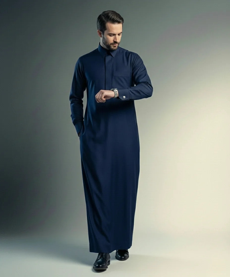 Walking view of Midnight Navy Executive Thobe displaying confident movement, refined elegance, premium tailoring, executive sophistication, and luxurious Gulf-inspired occasion wear ideal for weddings, Eid gatherings, business events, and formal celebrations. إطلالة أثناء المشي لثوب كحلي داكن فاخر تعكس الثقة والرقي والفخامة الهادئة للمناسبات الرسمية والاحتفالات الراقية.