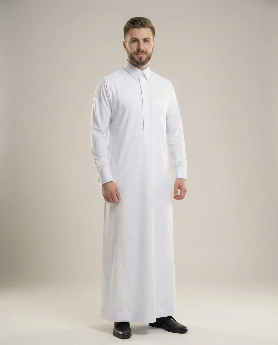Front view of Pure White Prestige Thobe displaying elegant tailoring, premium fabric, concealed placket design, executive sophistication, and timeless Gulf style ideal for weddings, formal gatherings, business events, Eid celebrations, and luxury menswear collections. إطلالة أمامية لثوب أبيض فاخر تعكس الرقي والأناقة والفخامة المناسبة للمناسبات الرسمية والاحتفالات الراقية.
