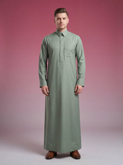 Sage Green Classic Thobe Elevated Everyday Wear featuring concealed front placket, premium tailoring, breathable fabric, elegant shirt collar, and modern Saudi-inspired design. Luxury Saudi thobe, men's Islamic clothing, premium jubba, ثوب سعودي رجالي, ثوب أخضر سيج, ثوب أخضر فاتح فاخر, ثوب رسمي للرجال, جلابية رجالية كلاسيكية, دشداشة رجالية حديثة, modest fashion ideal for Jummah prayer, work, Eid celebrations, Ramadan gatherings, and everyday sophistication.
