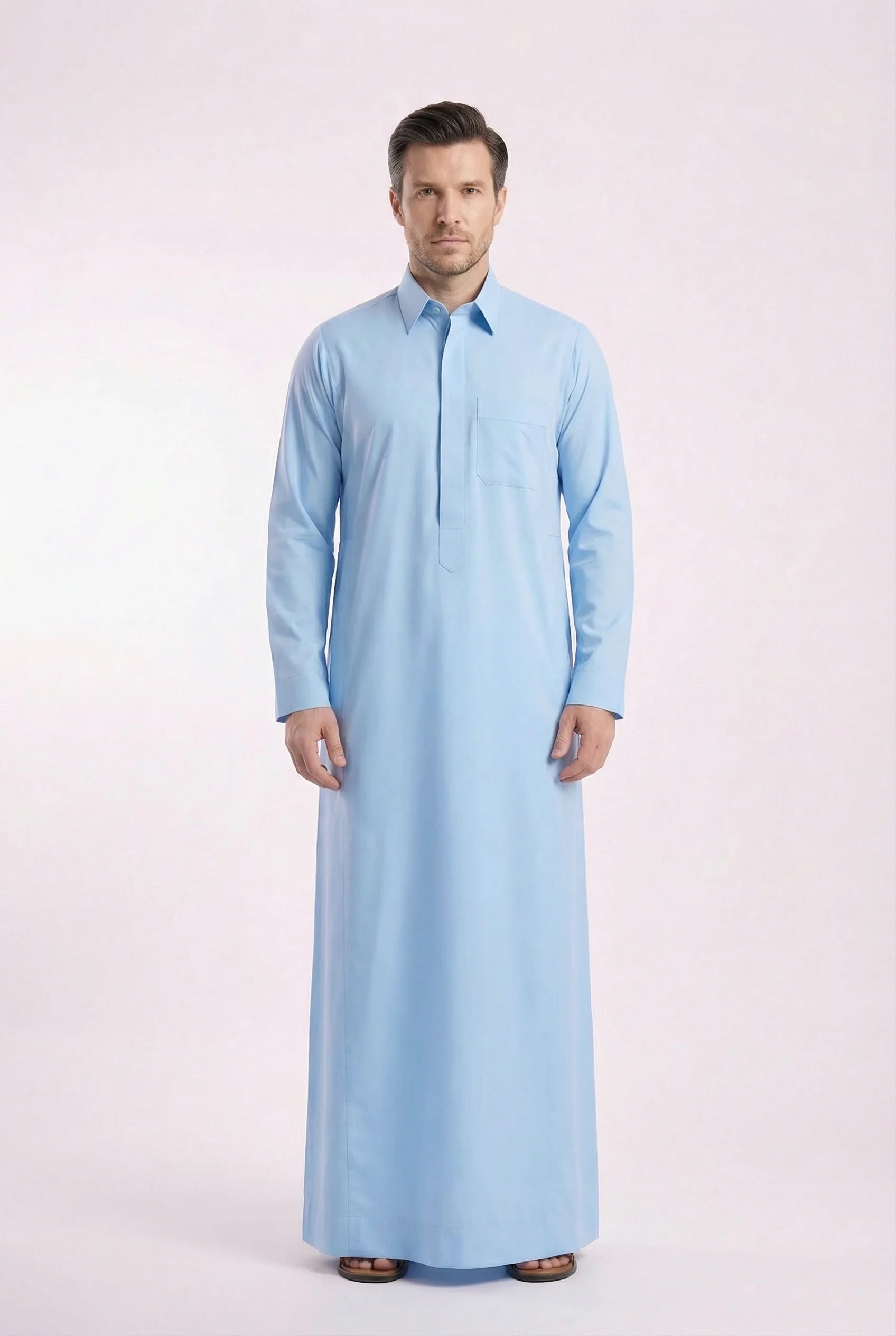 Side profile of Sky Blue Classic Everyday Thobe highlighting modern tailoring, streamlined silhouette, structured collar, and lightweight breathable fabric. Luxury men's thobe, Saudi jubba, Arabic clothing, ثوب سعودي أنيق, ثوب رجالي فاخر, ثوب أزرق فاتح, دشداشة رجالية رسمية, جلابية رجالية مودرن, premium Islamic menswear crafted for professional environments, Ramadan evenings, Eid celebrations, and elevated daily wear.