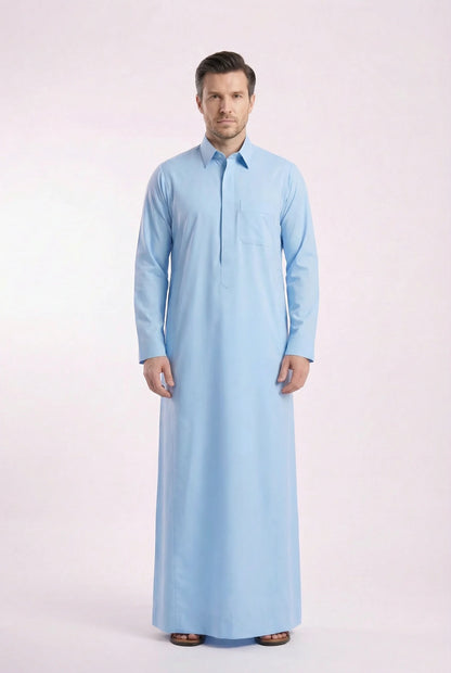 Side profile of Sky Blue Classic Everyday Thobe highlighting modern tailoring, streamlined silhouette, structured collar, and lightweight breathable fabric. Luxury men's thobe, Saudi jubba, Arabic clothing, ثوب سعودي أنيق, ثوب رجالي فاخر, ثوب أزرق فاتح, دشداشة رجالية رسمية, جلابية رجالية مودرن, premium Islamic menswear crafted for professional environments, Ramadan evenings, Eid celebrations, and elevated daily wear.