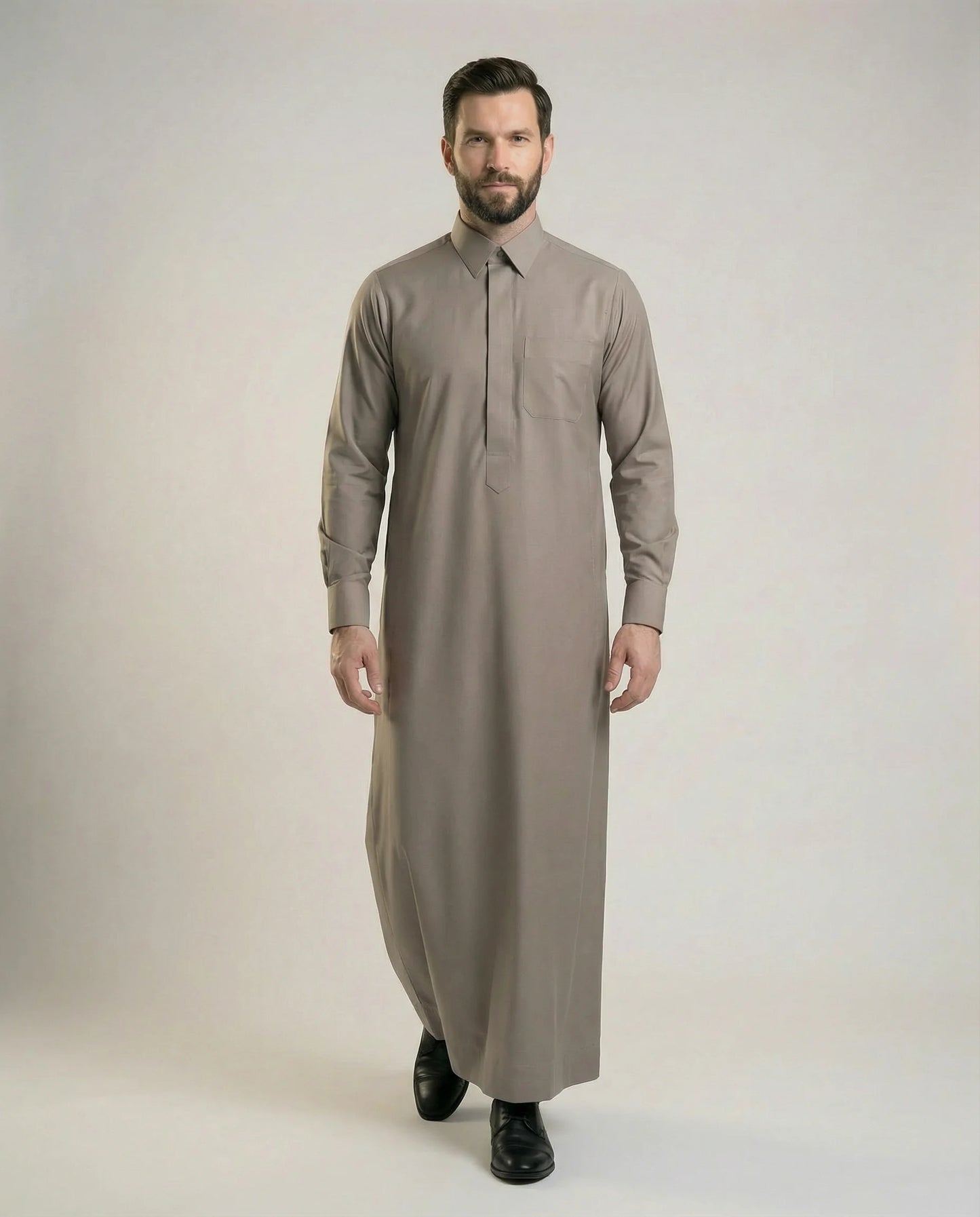 Walking view of Warm Grey Luxury Thobe displaying confident movement, premium comfort, refined elegance, sophisticated tailoring, and timeless occasion wear styling ideal for weddings, Nikah ceremonies, Eid gatherings, and prestigious events. إطلالة أثناء المشي لثوب رمادي دافئ فاخر تعكس الثقة والرقي والأناقة الهادئة مع راحة استثنائية للمناسبات والاحتفالات الراقية.