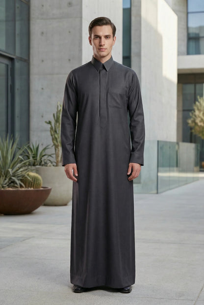 Charcoal Grey Signature Executive Saudi Thobe styled in a contemporary luxury setting, showcasing premium Islamic menswear with modern tailoring and timeless Arab elegance. Luxury Saudi thobe, men's designer thobe, premium jubba, ثوب سعودي فاخر للرجال, ثوب رجالي أنيق, جلابية رجالية فخمة, دشداشة رجالية راقية, ملابس إسلامية رجالية, modest fashion for professionals seeking refined style for Ramadan, Eid, formal occasions, business events, and distinguished everyday wear.