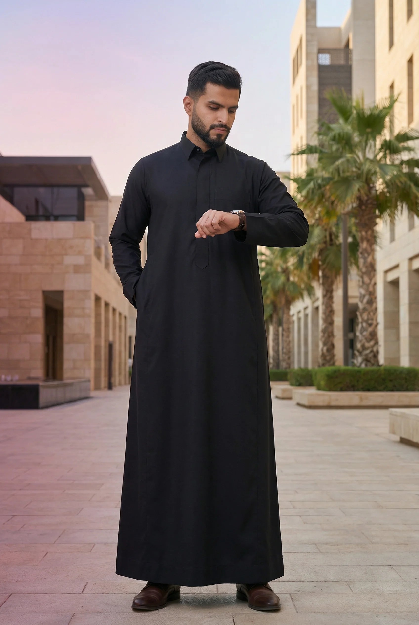 Deep Black Classic Thobe styled in a luxury urban setting, showcasing confidence, authority, and timeless elegance. Premium Saudi thobe, luxury men's jubba, Islamic menswear, ثوب أسود فاخر للرجال, ثوب سعودي أنيق, ثوب رجالي رسمي, جلابية رجالية راقية, دشداشة رجالية فاخرة, ملابس إسلامية رجالية, premium modest fashion suitable for professionals, Ramadan, Eid, prayer, family gatherings, and elevated everyday wear.