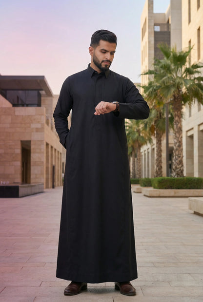 Deep Black Classic Thobe styled in a luxury urban setting, showcasing confidence, authority, and timeless elegance. Premium Saudi thobe, luxury men's jubba, Islamic menswear, ثوب أسود فاخر للرجال, ثوب سعودي أنيق, ثوب رجالي رسمي, جلابية رجالية راقية, دشداشة رجالية فاخرة, ملابس إسلامية رجالية, premium modest fashion suitable for professionals, Ramadan, Eid, prayer, family gatherings, and elevated everyday wear.