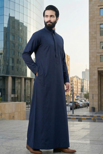 Midnight Blue Classic Thobe Refined Everyday Elegance styled in a modern urban environment, showcasing premium Islamic menswear with timeless Arab elegance and sophisticated tailoring. Luxury Saudi thobe, men's designer thobe, premium jubba, ثوب سعودي فاخر للرجال, ثوب أزرق كحلي, ثوب رجالي أنيق, جلابية رجالية فخمة, دشداشة رجالية راقية, ملابس إسلامية رجالية, ثوب يومي فاخر, modest fashion designed for professionals seeking confidence, comfort, elegance, and versatility throughout Ramadan, Eid, business meeting